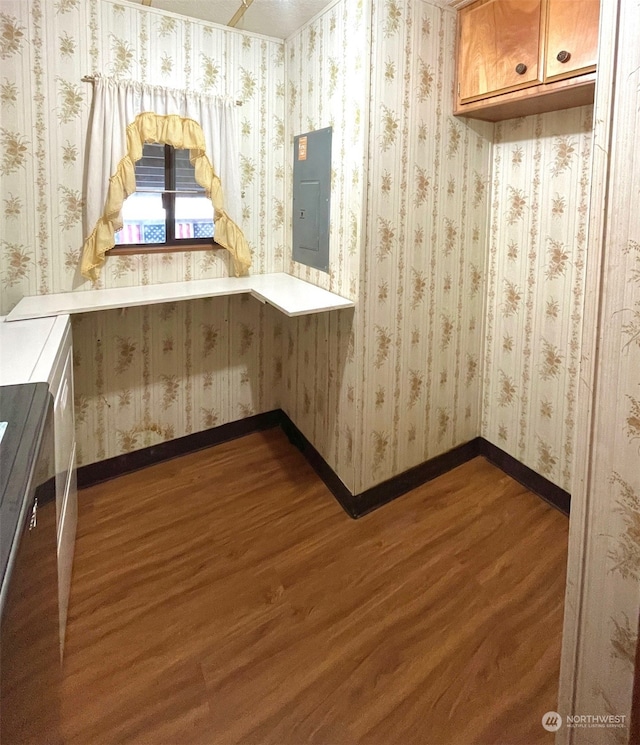 bathroom featuring electric panel and hardwood / wood-style flooring