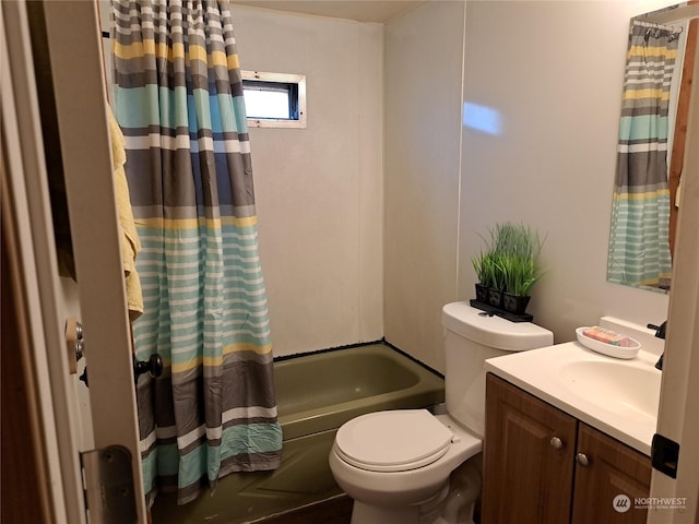 full bathroom with vanity, shower / bath combo, and toilet