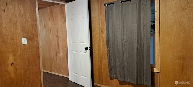 bathroom featuring wooden walls and hardwood / wood-style floors