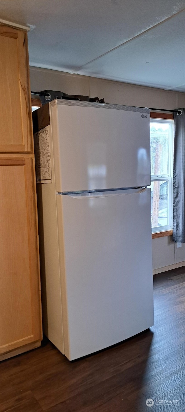 kitchen with dark hardwood / wood-style floors, white fridge, and light brown cabinetry