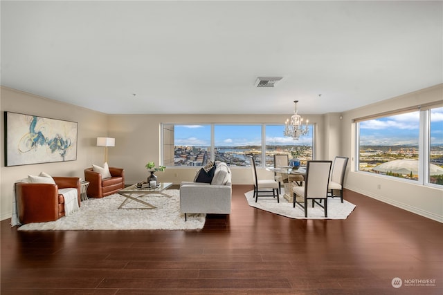 living room with a notable chandelier and dark hardwood / wood-style flooring