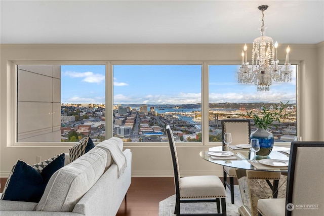 3201 Pacific Ave Unit 1201, Tacoma, WA 98418 - dining room featuring a chandelier, wood finished floors, crown molding, and baseboards