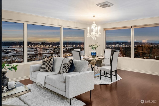 3201 Pacific Ave Unit 1201, Tacoma, WA 98418 - living room featuring wood finished floors, a chandelier, baseboards, and crown molding