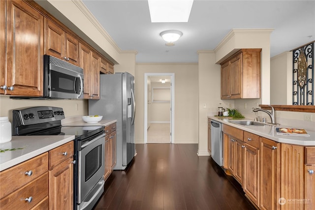 3201 Pacific Ave Unit 1201, Tacoma, WA 98418 - kitchen featuring stainless steel appliances, a sink, brown cabinets, a skylight, and light countertops