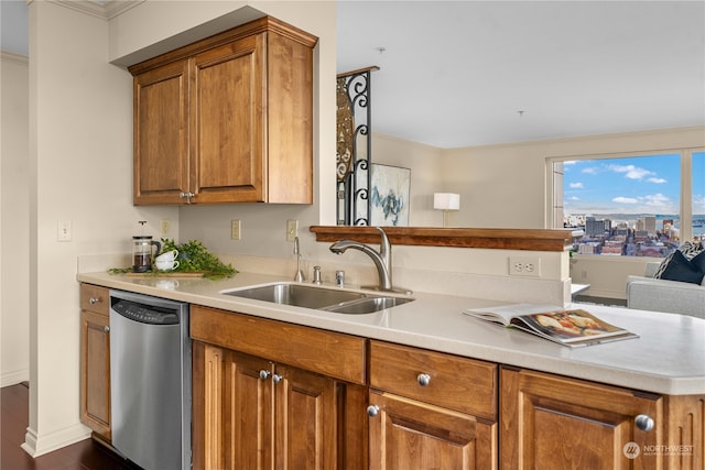 kitchen with ornamental molding, kitchen peninsula, dishwasher, and sink