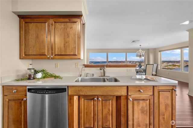 kitchen featuring wood-type flooring, sink, dishwasher, decorative light fixtures, and a chandelier