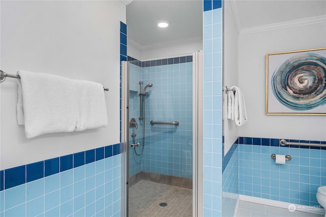 bathroom with toilet, tile patterned flooring, crown molding, tile walls, and an enclosed shower