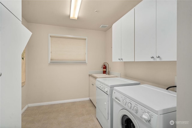 3201 Pacific Ave Unit 1201, Tacoma, WA 98418 - laundry area featuring washing machine and clothes dryer, cabinet space, and baseboards