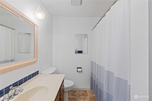 bathroom featuring toilet, vanity, and tile patterned floors