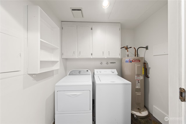 washroom with independent washer and dryer, electric water heater, and cabinets