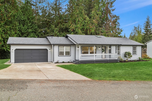 ranch-style house featuring a front lawn, covered porch, and a garage