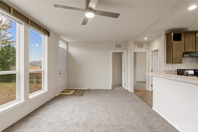 kitchen with ceiling fan, extractor fan, black range with electric stovetop, and light colored carpet