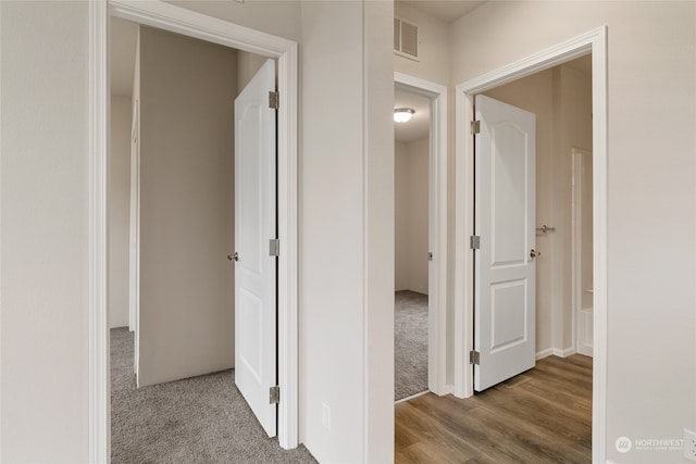 corridor with light hardwood / wood-style floors