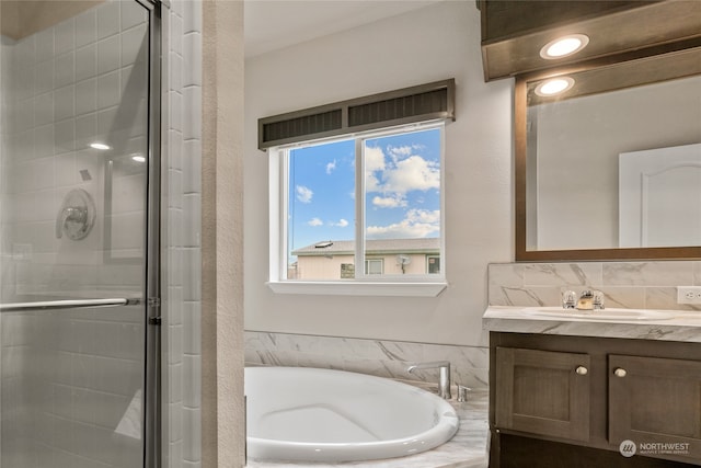 bathroom with vanity and separate shower and tub