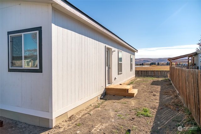 view of side of home with a mountain view