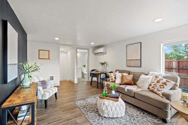 living room with light wood-type flooring and a wall mounted AC