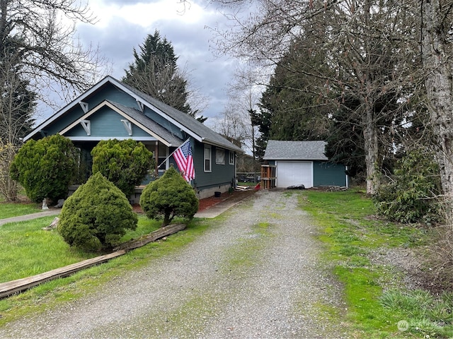 view of front of house featuring a garage and an outdoor structure
