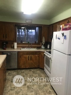 kitchen with stainless steel dishwasher, stove, white fridge, dark brown cabinetry, and sink