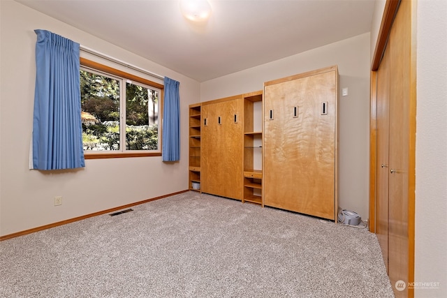 unfurnished bedroom featuring carpet floors and a closet