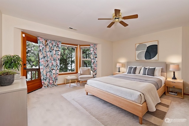 carpeted bedroom with ceiling fan and multiple windows