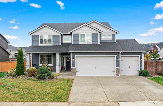 view of front of property with a garage and a front lawn