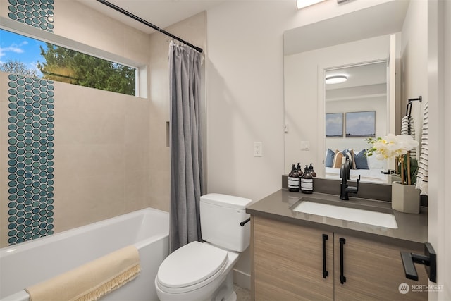 full bathroom featuring vanity, shower / tub combo with curtain, and toilet