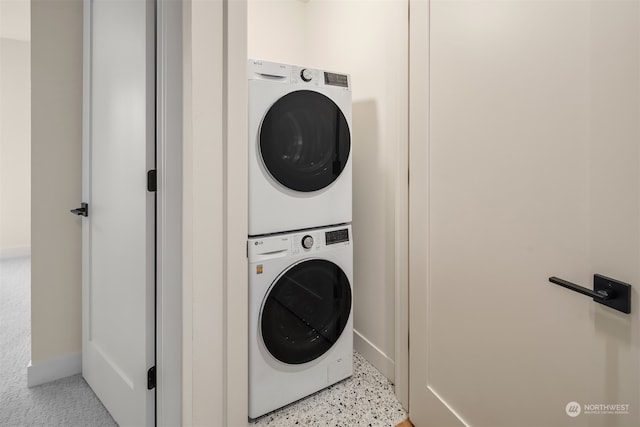 clothes washing area featuring stacked washer / drying machine