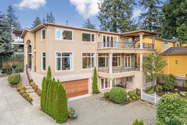 view of front of home featuring a balcony and a garage