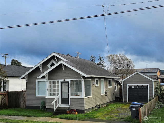 bungalow with an outbuilding and a garage