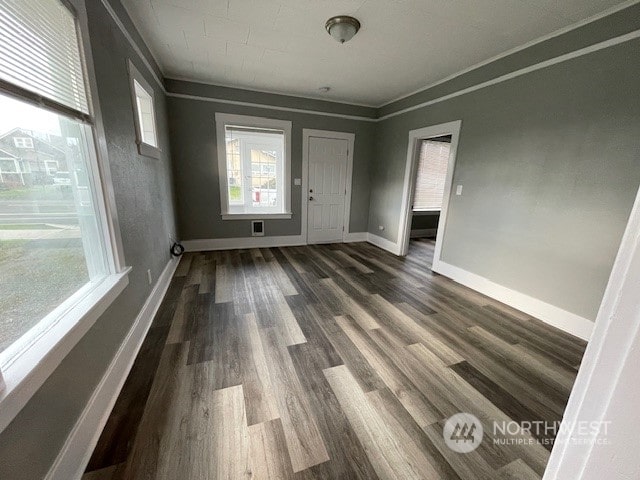 unfurnished room with crown molding and dark hardwood / wood-style floors