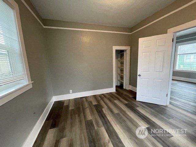 unfurnished bedroom with dark hardwood / wood-style flooring