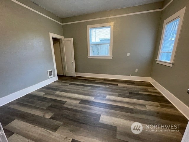 spare room with dark hardwood / wood-style floors