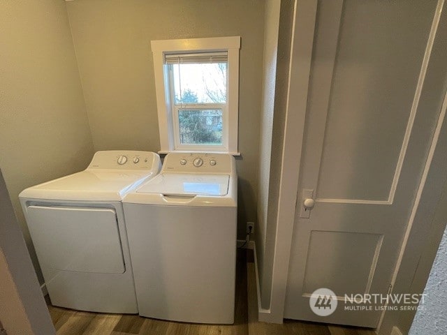 laundry area with wood-type flooring and washing machine and dryer