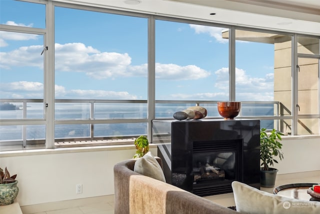 sunroom / solarium featuring a water view