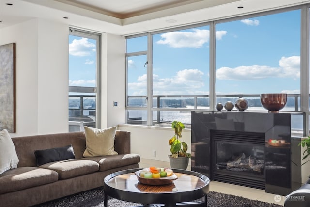 living room featuring light tile patterned flooring and a water view