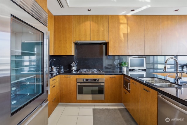 kitchen with decorative backsplash, ventilation hood, sink, light tile patterned flooring, and appliances with stainless steel finishes