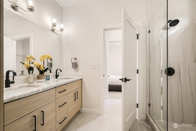 bathroom featuring vanity and a shower with shower door