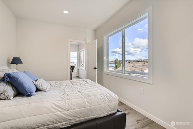 bedroom with hardwood / wood-style floors