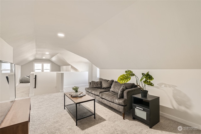 carpeted living room featuring vaulted ceiling