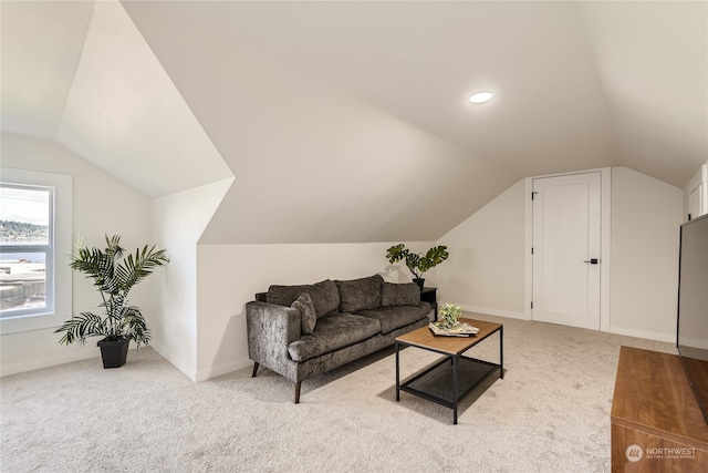 carpeted living room featuring vaulted ceiling