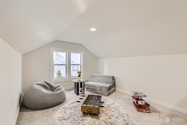 sitting room featuring carpet flooring and lofted ceiling