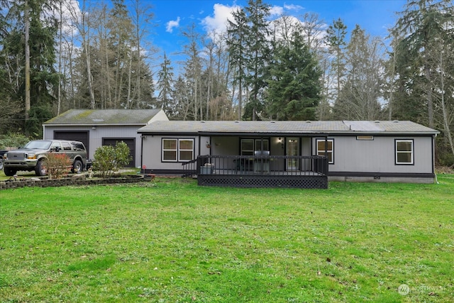 back of property with a yard and a garage