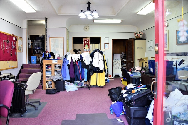 misc room featuring an inviting chandelier and carpet flooring