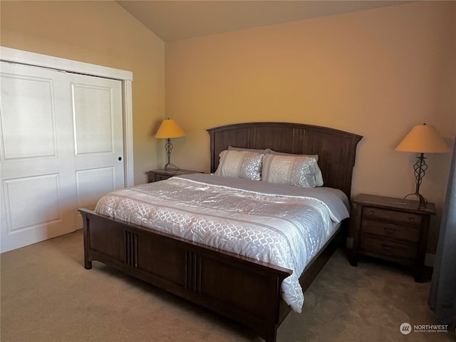 carpeted bedroom featuring a closet and vaulted ceiling