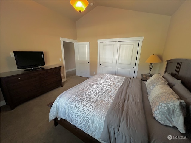 carpeted bedroom featuring a closet and vaulted ceiling