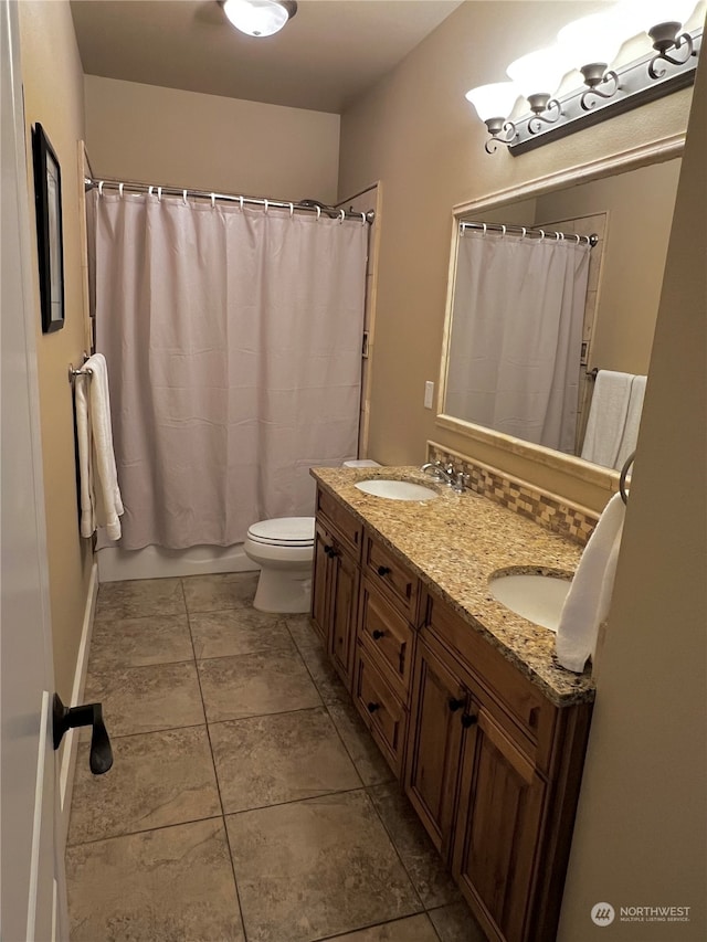 bathroom with vanity, toilet, and tile patterned flooring