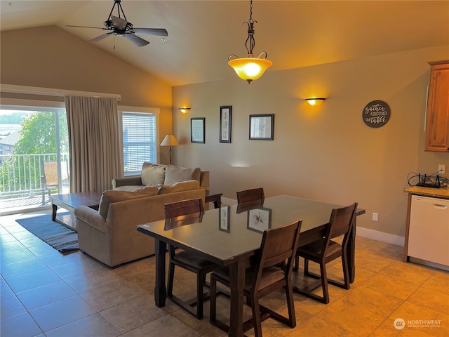 tiled dining room with ceiling fan and vaulted ceiling