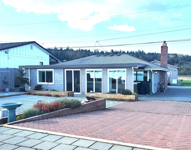 back of property with a garage