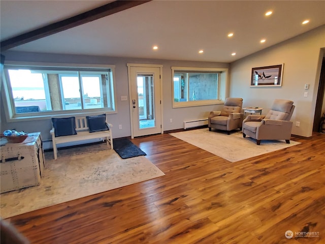 living room featuring a baseboard heating unit, vaulted ceiling with beams, and hardwood / wood-style floors