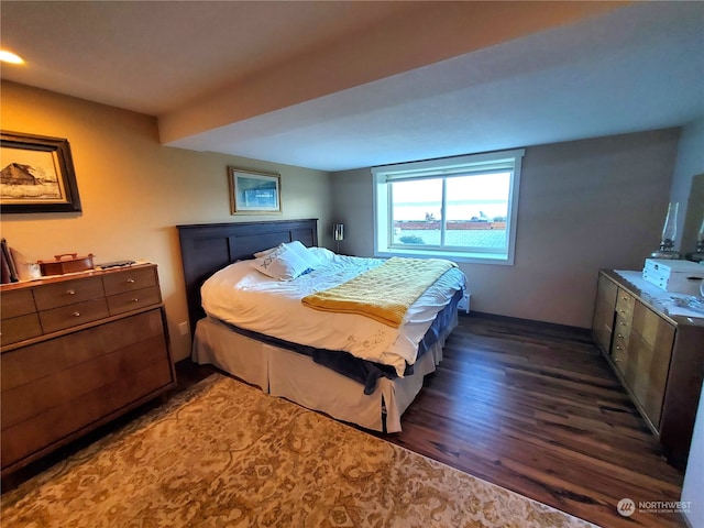 bedroom with dark hardwood / wood-style flooring